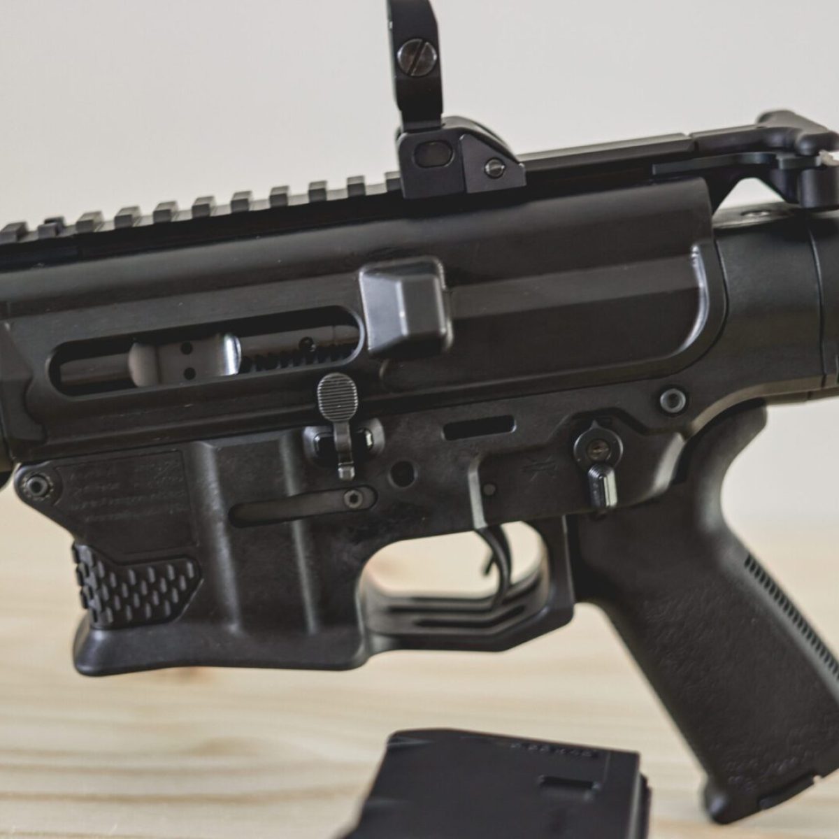 double barrel AR15 rifle focus on the pistol grip, trigger, safety, mag well, extraction point and picatinny rails.